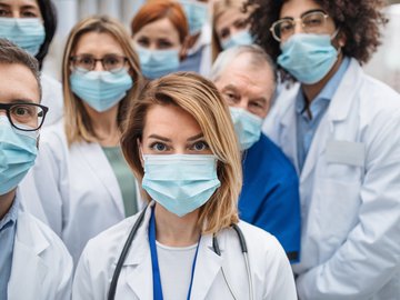 Group of doctors with face masks looking at camera