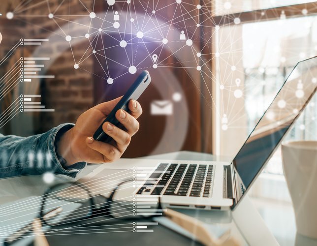 Close-up photo of male hands with laptop. Man working remotely at home. Concept of networking or remote work. Global business network.