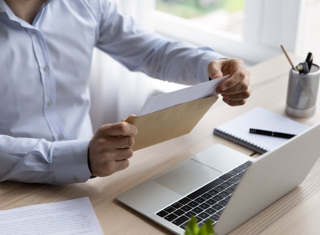 office, laptop, envelope with documents
